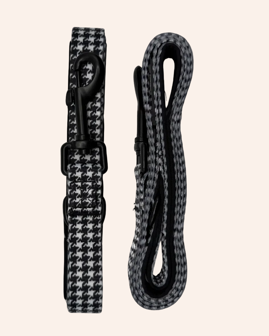 Black and white houndstooth patterned dog lead set on a white background